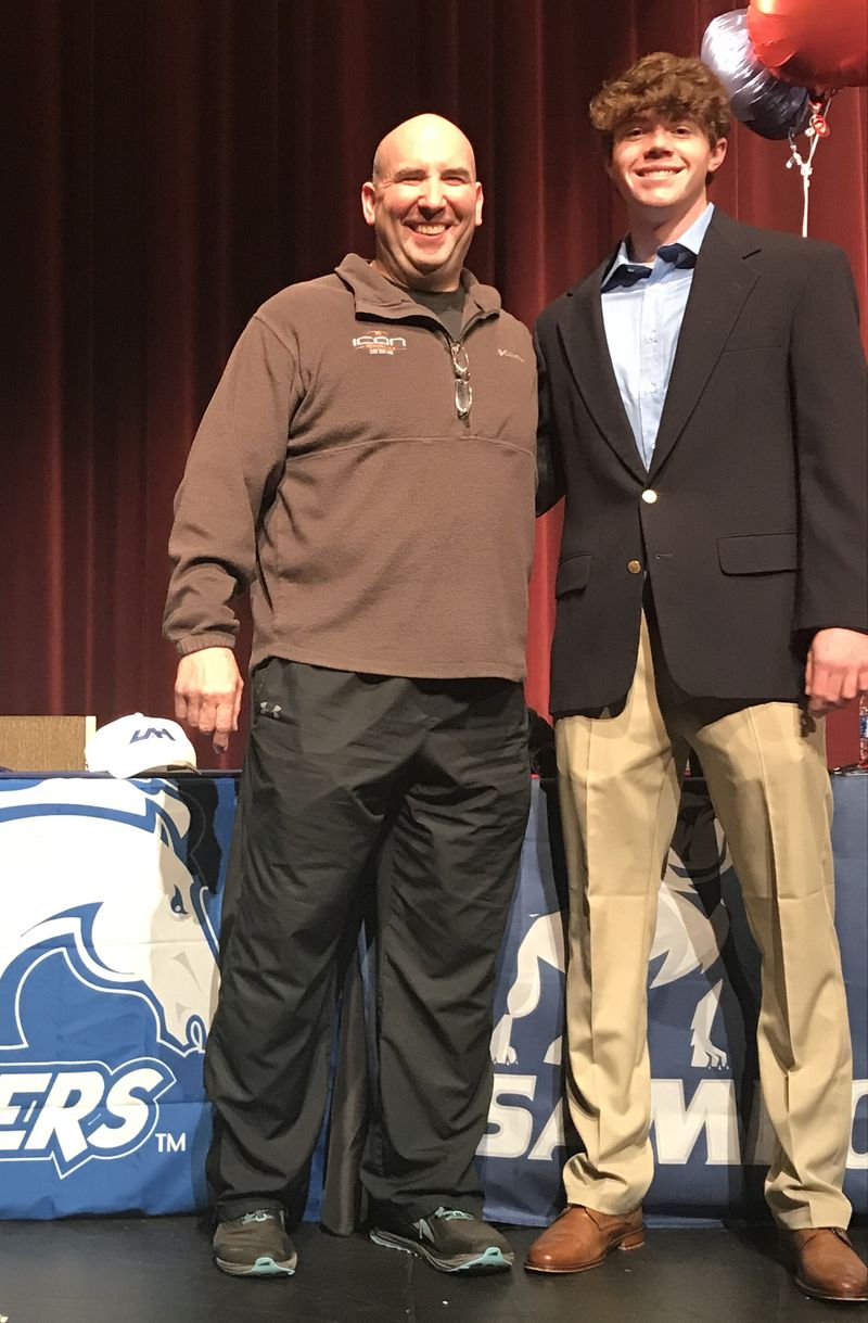 Icon coach with a college signee at a signing ceremony